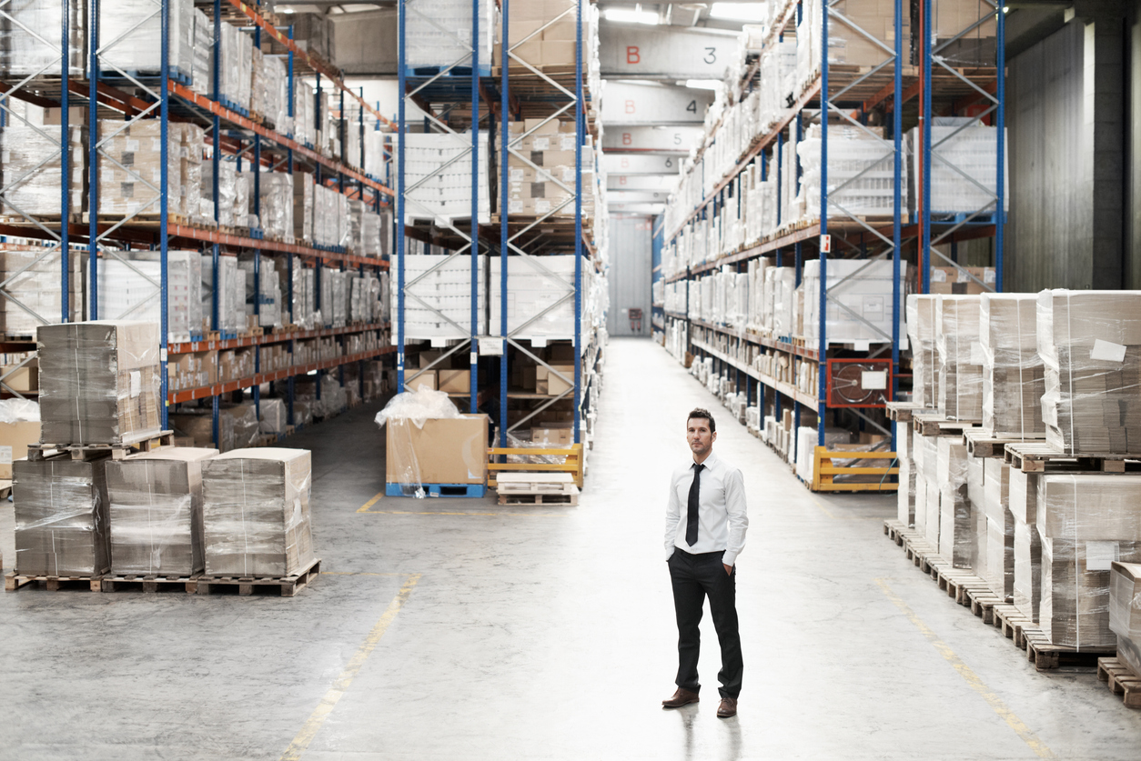 Man standing in the warehouse with racking